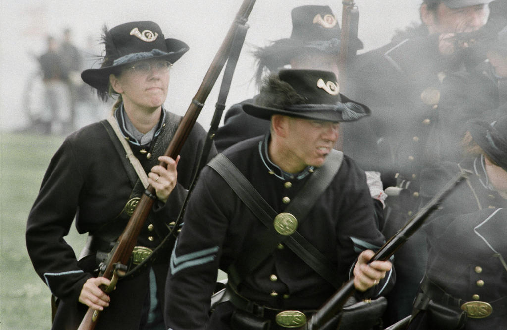 At an American Civil War reenactment in England Paula Mountain Agar, left, portrays a male Union soldier and fights alongside her husband, Gregory Agar during a reenactment at Stanford Hall in Leicester.