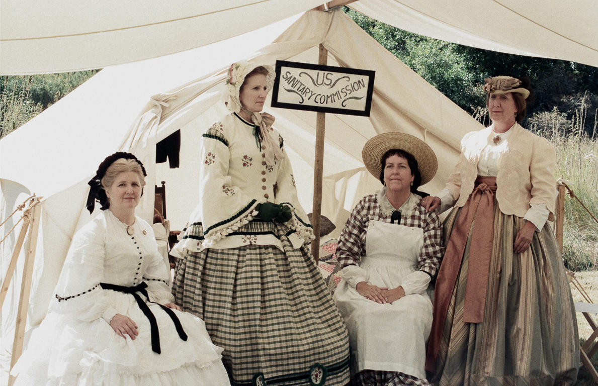 Women at a Civil War reenactment in California portray members of the United States Sanitary Commission, who provided care for the sick and injured during the war. The group was a forerunner of the American Red Cross.